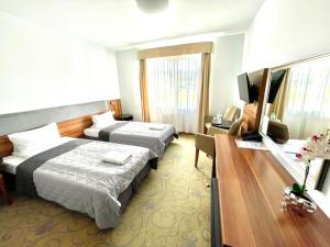 Postel nebo postele na pokoji v ubytování Hotel Komfort