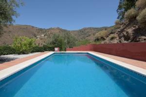 a blue swimming pool with a mountain in the background at House with Private Pool (Herrera) in Arenas