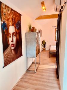 a hallway with a painting of a woman on the wall at Echternacher Hof - Moselloft in Kinheim