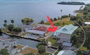 an aerial view of a house next to the water at Sarasota Bay in Bradenton