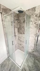 a shower with a glass enclosure in a bathroom at Aaby House in London in Croydon