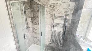 a bathroom with a shower with a glass door at Aaby House in London in Croydon