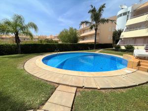 a swimming pool in a yard next to a building at Vilamoura Typical 1 With Pool by Homing in Vilamoura