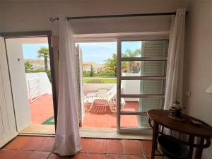 a room with a door open to a patio at Vilamoura Typical 1 With Pool by Homing in Vilamoura