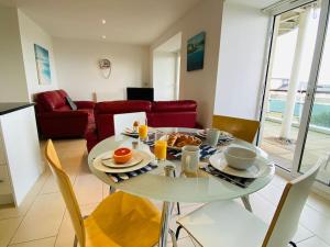 a dining room with a table with food on it at Quayside Apartment - Large and Spacious Duplex in Castletown