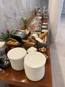 a buffet with white plates and baskets of food at Gartenhotel Altmannsdorf in Vienna