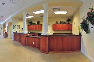 a large lobby with wooden cabinets and a lobbyasteryasteryasteryasteryasteryasteryastery at Lake view condo close to Disney in Orlando