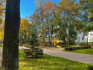 a playground with a slide in a park at Iris Hotels Resort in Vorzel