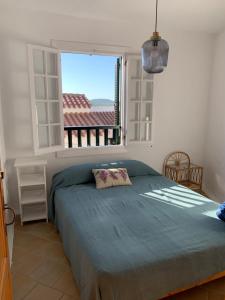 a bedroom with a large bed and a window at Apartamento en frente de la playa in Son Parc +13 photos