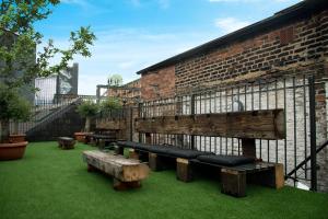 a group of benches in front of a brick building at Blayds Yard in Leeds