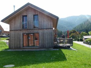 a small house on a green field with a mountain at Spatzennest in Hohentauern