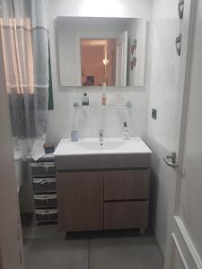 a bathroom with a sink and a mirror at CABO PARAISO in Costa de Antigua