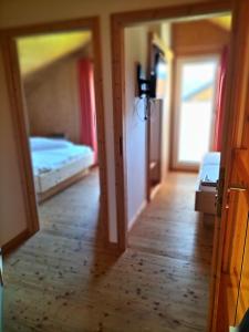 a view of a room with two beds and a mirror at Spatzennest in Hohentauern