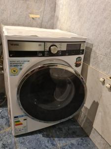 a washing machine is sitting in a bathroom at Benevo Hostel in Tbilisi City