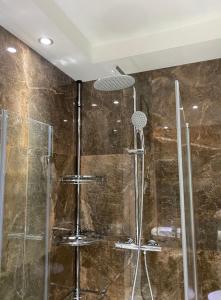 a bathroom with a shower with a glass at AT-Rooms in Hannover