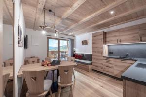 a kitchen with a table and chairs in a room at Gschlunerhof in Castelrotto