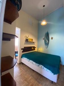 a bedroom with a large bed in a room at Casa Tribus Itamambuca in Ubatuba