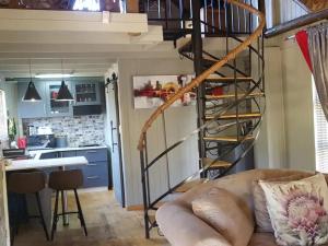 a spiral staircase in a tiny house at SHABBY FUFU LIFESTYLE FARM in Plettenberg Bay