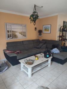 a living room with a couch and a table at Mas de la garrigue 13 in Saint Pierre La Mer