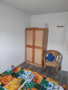 a bedroom with a bed and a chair at Mas de la garrigue 13 in Saint Pierre La Mer