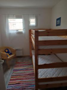 a bedroom with two bunk beds and a rug at Mas de la garrigue 13 in Saint Pierre La Mer
