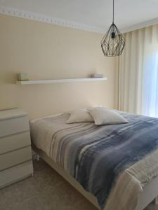 a bedroom with a bed and a pendant light at Casa suerte in Algorfa