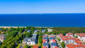 an aerial view of a town with houses and the ocean at Prawdzic Family Resort & Wellness in Gdańsk