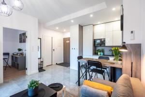 a living room and kitchen with a couch and a table at Apartament LUX 3 Cieplice in Jelenia Góra +7 photos