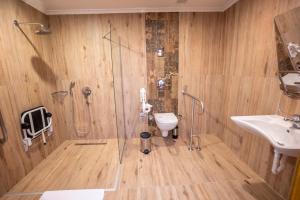 a bathroom with a shower and a toilet and a sink at Azka Hotel in Bodrum City