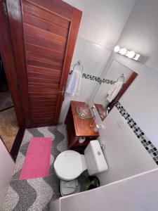 a small bathroom with a toilet and a sink at Residencial Bem-te-vi in Jericoacoara