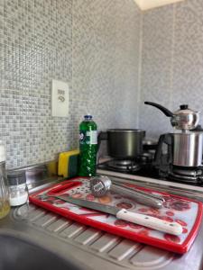 a kitchen counter with a stove with a pot on it at Residencial Bem-te-vi in Jericoacoara
