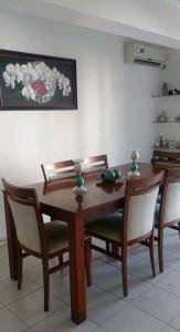 a dining room table with chairs and a table and ahibition at HERMOSO DPTO 2 dor TUCUMAN in San Miguel de Tucumán