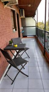 a patio with a table and a chair on a balcony at HERMOSO DPTO 2 dor TUCUMAN in San Miguel de Tucumán