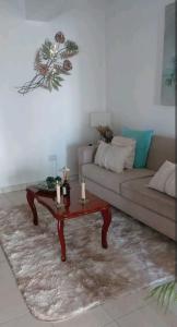 a living room with a couch and a coffee table at HERMOSO DPTO 2 dor TUCUMAN in San Miguel de Tucumán