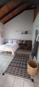 a bedroom with a bed and a couch at Mucha Airbnb in Walvis Bay