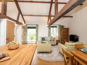 a living room with wooden beams at Monkey Puzzle Cottage in Sedbergh