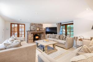 a living room with two couches and a fireplace at Rose Walls in Stainton