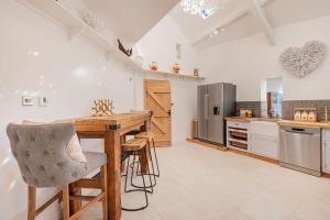 a kitchen with a wooden table and chairs at Rose Walls in Stainton