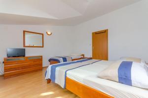 Postel nebo postele na pokoji v ubytování Apartments Milivoj