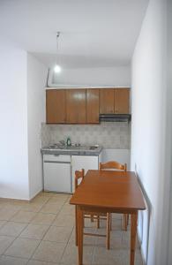 a kitchen with a table and a table and chairs at Armenistis appartments with a view in Armenistis