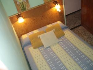 a bedroom with a bed with yellow pillows and a mirror at Apartment - 1 Bedroom with WiFi and Sea views - 01990 in Las Marciegas