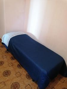 a blue bed in a corner of a room at Santi Palace Hotel in Gravina di Catania