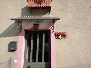 a door with a balcony on the side of a building at CASA INES in Stresa