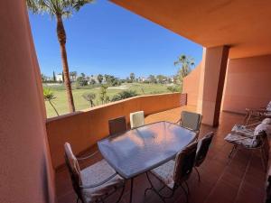 a patio with a table and chairs on a balcony at B2 Bajo con terraza de 32 m2 en Playa Granada in Motril