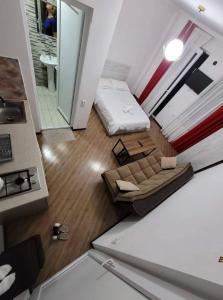 a view of a living room with a couch and a bed at Family house in Borjomi