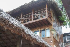 a wooden house with a thatched roof at Bella Vista Vacation in Montego Bay