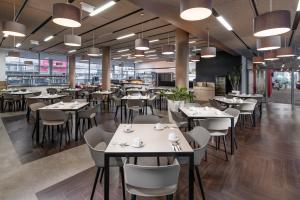 a dining room with tables and chairs in a restaurant at Clarion Congress Hotel Ústí nad Labem in Ústí nad Labem