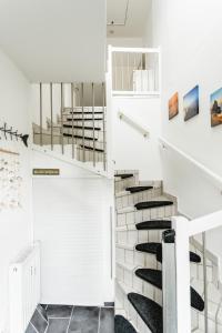a staircase in a house with white walls at Strandperle Alexander in Hofe
