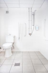 a white bathroom with a toilet and a shower at Campanile Hotel Glasgow SECC Hydro in Glasgow