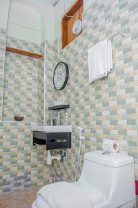 a bathroom with a toilet and a sink at Zanzibar Spice Nest Apartment in Stone Town